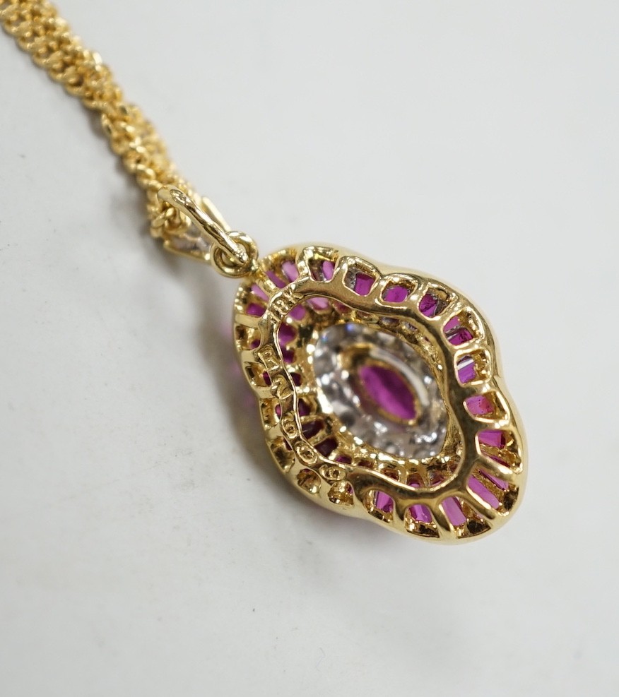 A modern 18k yellow metal, ruby and diamond cluster set quatrefoil shaped pendant, overall 25mm, on an 18ct gold fine link chain, 44cm, gross weight 8.1 grams.
